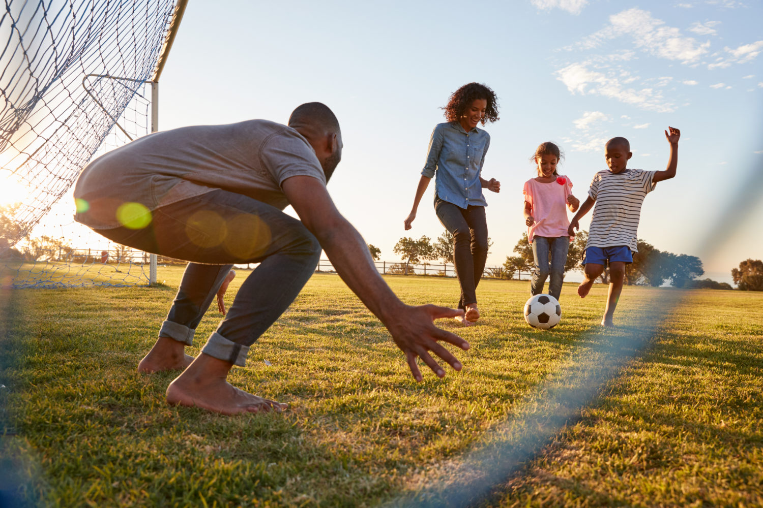 Family playing soccer